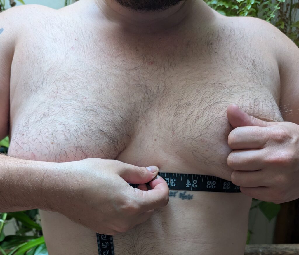 Measuring underbust rib circumference beneath chest tissue.